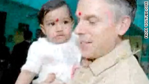 The vdeo shows Jon Huntsman with Asha Bharati, wearing the red tikka, a mark associated with the sacred in Hinduism.