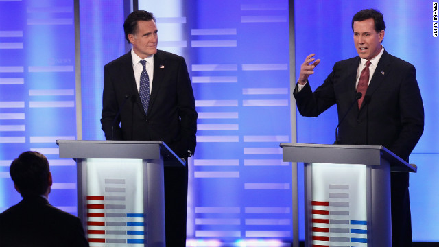 Mitt Romney listens to Rick Santorum duing the Republican presidential debate Saturday night in Manchester, New Hampshire.