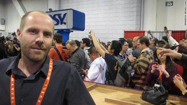 Xybotyx co-founder David Shafter in his CES booth, with Justin Bieber fans crowding in the background.