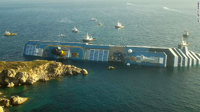 The huge ship, which which is now lying on its side in shallow water, was carrying about 3,200 passengers and 1,000 crew members when it ran aground at about dinner time.