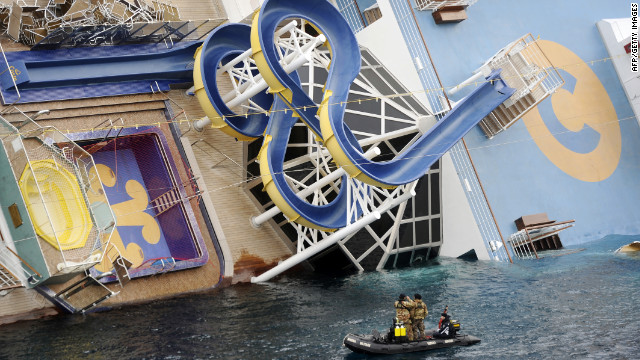 Military rescuers patrol next to the listing Costa Concordia on Sunday January 15. A spiraling water slide can be seen on the deck.