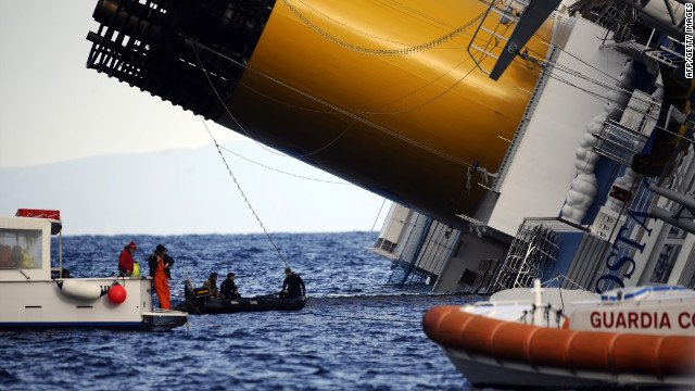 Boats patrol near the Costa Concordia on Sunday. Divers searched for people who were still missing after Friday's accident.