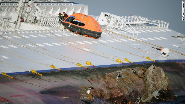 Rescuers search the Costa Concordia on Sunday.