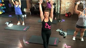 A Flirty Girl Fitness instructor teaches a class that\'s streaming live online to subscribers.