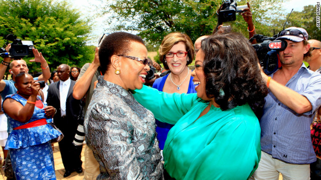 <br/>Winfrey greets Graca Machel, the wife of former South African president Nelson Mandela, on her arrival at the inaugural graduation of the class of 2011.