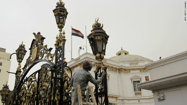 A worker cleans the gate leading to the parliament building in Cairo ahead of the first post-Mubarak session.