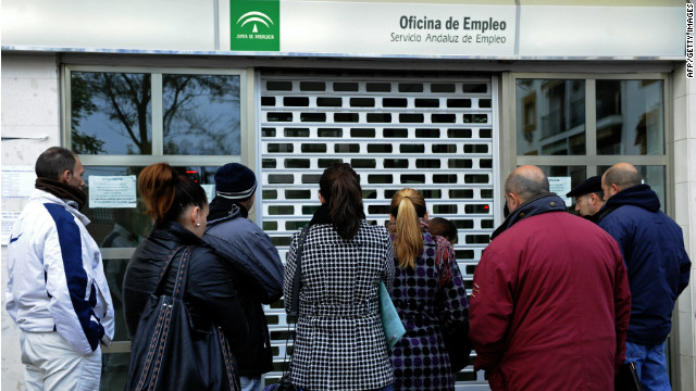 People wait in line in front of a government employment office in Sevilla, Spain, in early 2012.