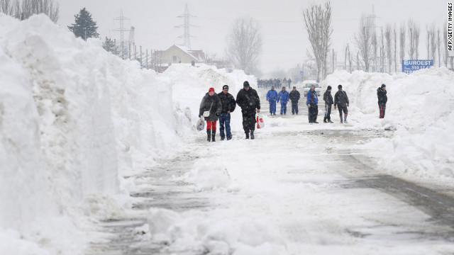 <br/>Freshly plowed snow frames a road in Bucharest, Romania, on Friday, January 27.