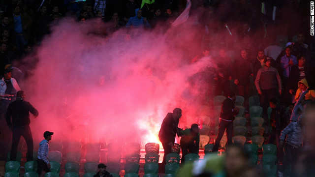 Flares are thrown in the stadium as tension builds throughout the game.