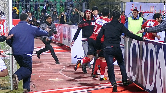 Al-Masry fans chase Al-Ahly players during riots that erupted after the football match.