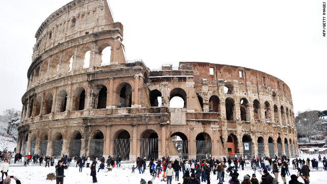 <br/>People stand in snow in front of the Colosseum on Saturday, February 4, in Rome. 