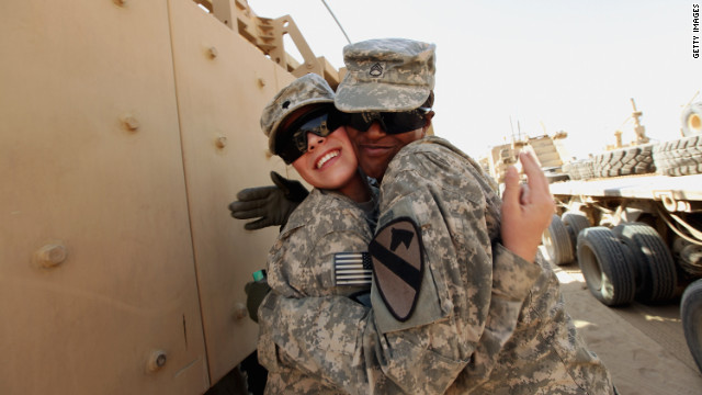 Spc. Ashley Walter, left, hugs Staff Sgt. Diana Royal after Royal arrived in the last U.S. military convoy to leave Iraq in December.