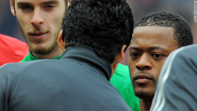 Patrice Evra and Luis Suarez (second left) fail to shake hands before the start of an English Premier League game.