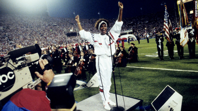 Houston gestures as she sings the national anthem before the start of Super Bowl XXV in 1991.