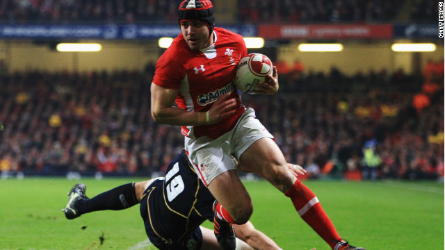 Wales full-back Leigh Halfpenny eludes a Scotland tackle to score his second try in Cardiff.