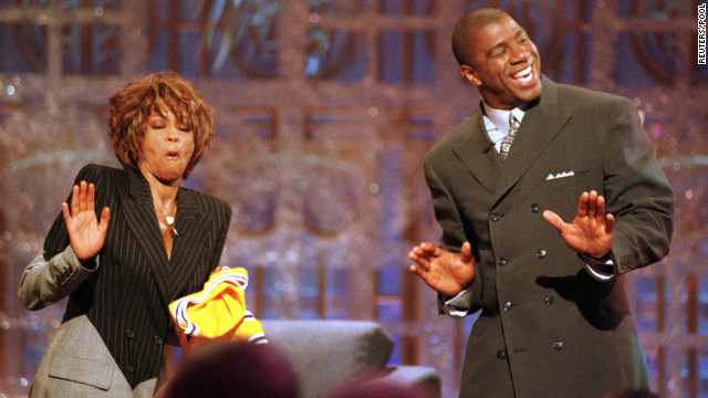 Basketball legend Magic Johnson and Houston dance during the taping of the 1998 premier of Johnson's television show, "The Magic Hour," in Los Angeles. 