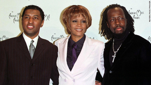 Kenneth "Babyface" Edmonds, left, Houston and Wyclef Jean pose for photographers after performing at the 26th annual American Music Awards in January 1999 in Los Angeles. 