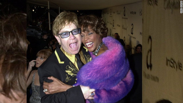 Elton John and Houston embrace during the Academy Awards show in Los Angeles in March 2001. 