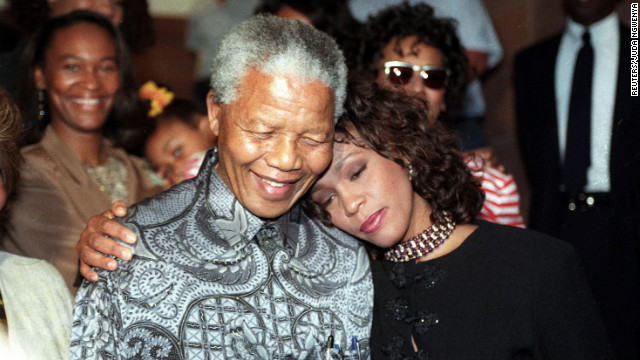 South African President Nelson Mandela hugs Houston in November 1994.