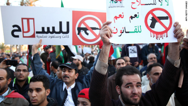 Libyan demonstrators hold banners that read, 