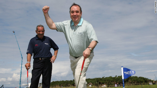 Scoltand's first minister Alex Salmond is a keen golf fan but his government faces a difficult decision over the off shore windfarm.
