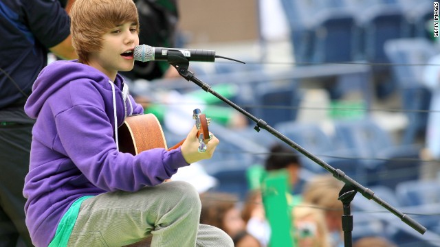 The Stratford, Ontario, native first attracted attention on YouTube. Here Bieber, in his signature purple hoodie, entertains crowds at Arthur Ashe Kids' Day, a U.S. Open event, in New York in August 2009.