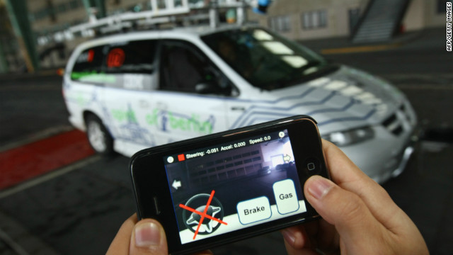 A student at the Freie Universitaet Berlin steers a converted Dodge minivan remotely with an iPhone in November 2009.