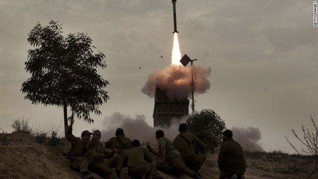 Israeli soldiers watch a missile launch from the Iron Dome defense system in the southern Israeli city of Beer Sheva on Monday.