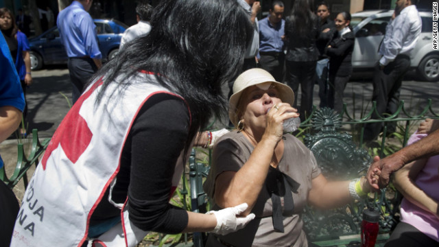 A member of the Mexican Red Cross assists a woman in Mexico City.