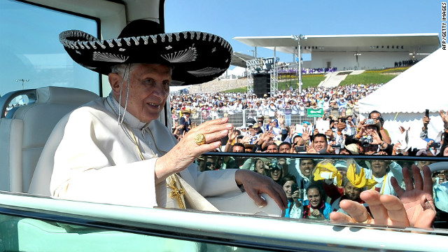 Wearing a large Mexican sombrero, Benedict waves to the crowd.