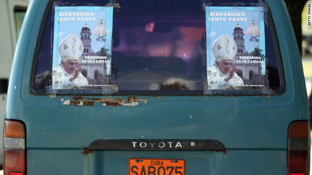 Posters on the back of a van welcome Pope Benedict XVI at Revolution Square in Santiago de Cuba on Monday. 