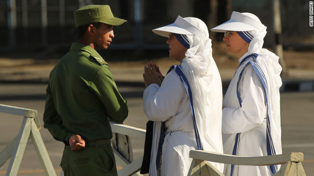 Sisters with Mother Teresa's Missionaries of Charity speak to a member of the Cuban military at Antonio Maceo Revolution Square.