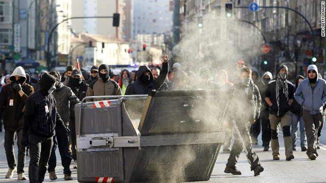 Protesters walks past a waste container in Burgos during a national strike on March 29.