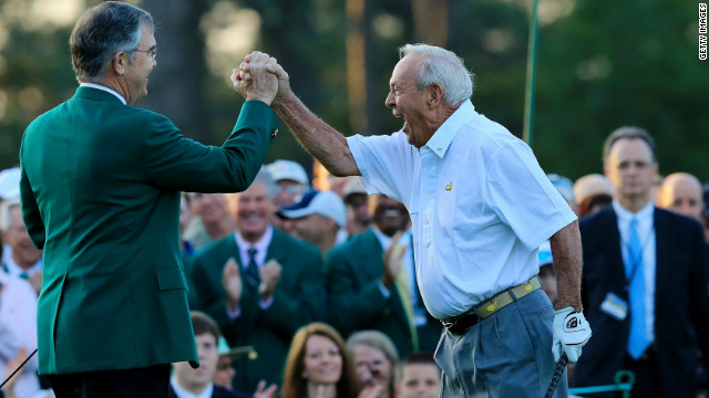 Arnold Palmer, right, celebrates with Augusta National president Billy Payne after launching the 2012 Masters with a ceremonial tee shot 50 years after his "Annus Mirabilis." Palmer was joined by fellow golf legends Jack Nicklaus and Gary Player in making the honorary drives down the fairway.