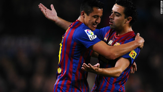 Alexis Sanchez of Barcelona celebrates with his teammate Xavi Hernandez after scoring the opener in the Nou Camp.