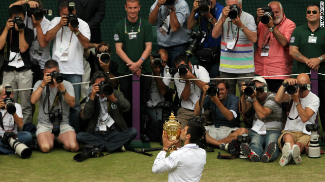 Djokovic plays up to the cameras after winning his first Wimbledon in 2011, beating Nadal 6-4 6-1 1-6 6-3 in a final lasting two hours, 28 minutes.