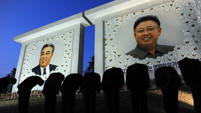 North Korean citizens bow before the portraits of the founding father Kim Il-Sung, left, and his son Kim Jong-Il, in Pyongyang, North Korea on Monday, April 9. April 15 marks the 100-year anniversary of the founder's birth and journalists have been allowed inside the country.