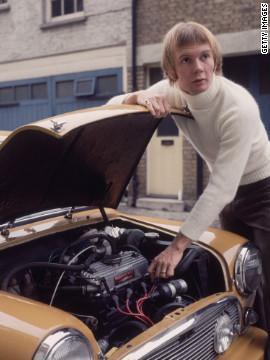 Australian musician Colin Petersen, a drummer with the popular disco group The Bee Gees, tinkering under the hood of his car in 1965.