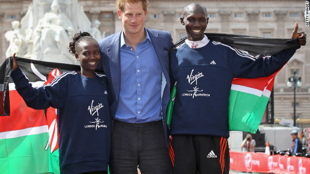 Prince Harry celebrates with marathon winners Mary Keitany and Wilson Kipsang, both of Kenya. Claire Squires had been less than a mile from the finishing line at The Mall when she collapsed and died. 