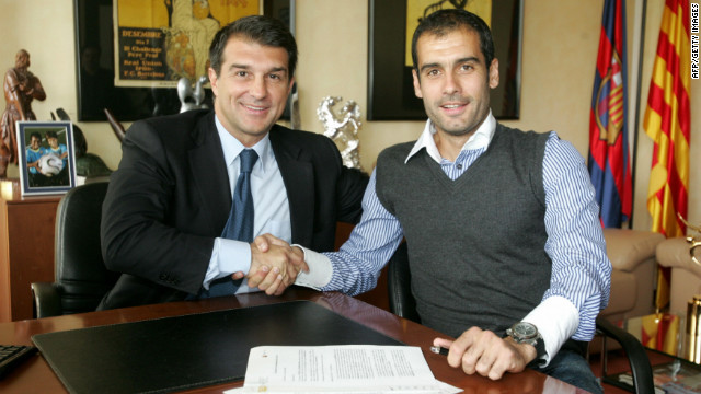 Former Barcelona president Joan Laporta shakes hands with Guardiola on June 5, 2008. The Catalan club's 15th coach arrived with the mission to end a two-season trophy drought -- he didn't disappoint.