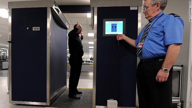 A security officer demonstrates the body scanner at the airport in Manchester, England, in 2010.