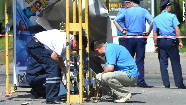 Police experts examine one of the explosion sites in Dnipropetrovsk, where four bombs were let off in rubbish bins on Friday. At least 30 people were injured, raising serious concerns over safety at next month's European Championships.