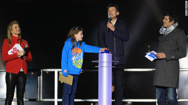 Nine-year-old schoolgirl Niamh Clarke-Willis makes history as she presses the button to officially open the Olympic stadium along with London 2012 chairman Sebastian Coe. They were joined on stage by TV presenters Gabby Logan and Vernon Kay. 