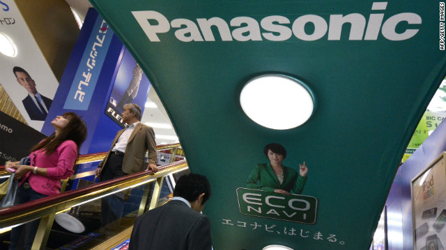 People ride an escalator past a Panasonic advertisement in Tokyo.