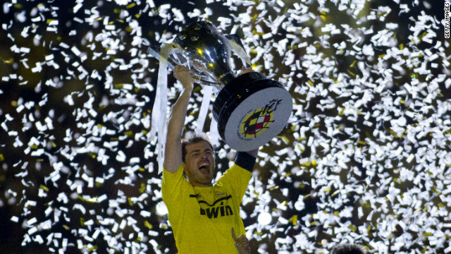 Real Madrid captain Iker Casillas lifts the Spanish Primera Division trophy after Jose Mourinho's team defeated Mallorca 4-1 on Sunday. The 32-time Spanish champions finished the season with 100 points, a record amount.