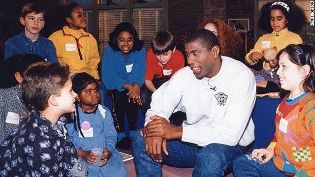 Hydeia Broadbent, in blue dress, sits next to Magic Johnson in a TV special for Nickelodeon 20 years ago.
