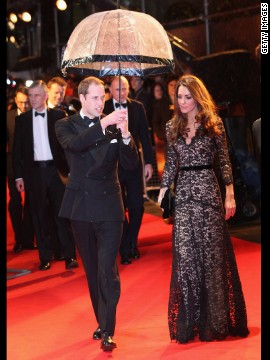 Prince William kept his wife dry at the London premiere of "War Horse" on January 8. She wore a black lace <a href='http://nymag.com/daily/fashion/2012/01/kate-middleton-war-horse-premiere-temperley.html' >Alice by Temperley</a> gown and carried a black clutch.