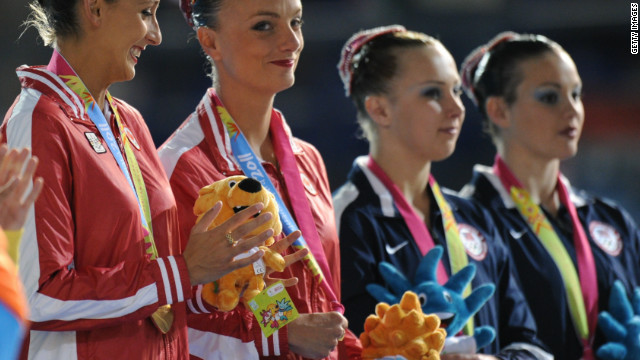 Killman and Koroleva (right) on the podium of the 2011 Pan American Games, where they won the silver medal behind the Canadian pair in the duet competition.