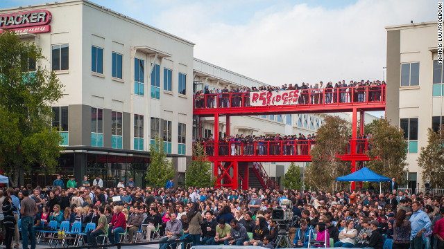 A crowd gathers in an outdoor plaza, dubbed Hackers Square, to hear Facebook's CEO kick off the Hackathon. 