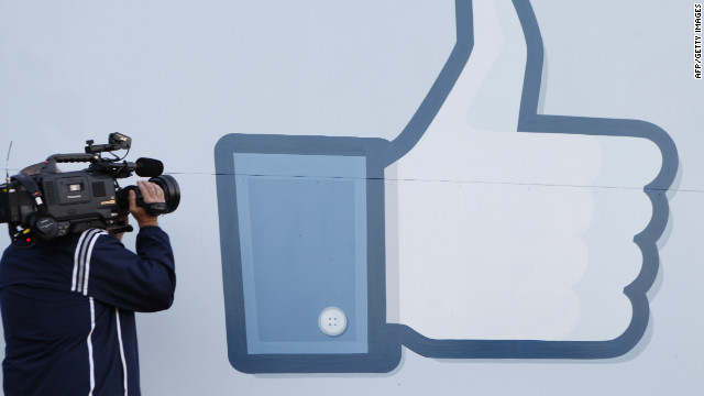 A videographer shoots the side of Facebook's Like Button logo at Facebook Headquarters in Menlo Park, California.